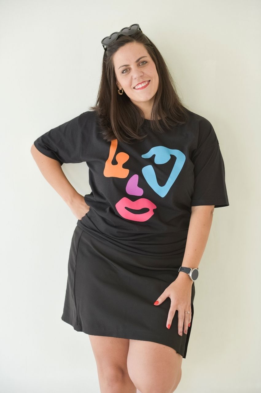 Woman wearing black t-shirt with colorful abstract face graphic modern fashion South Africa