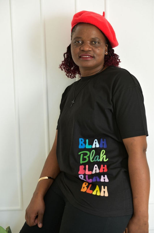 Woman wearing black t-shirt with colorful Blah text graphic casual fashion South Africa