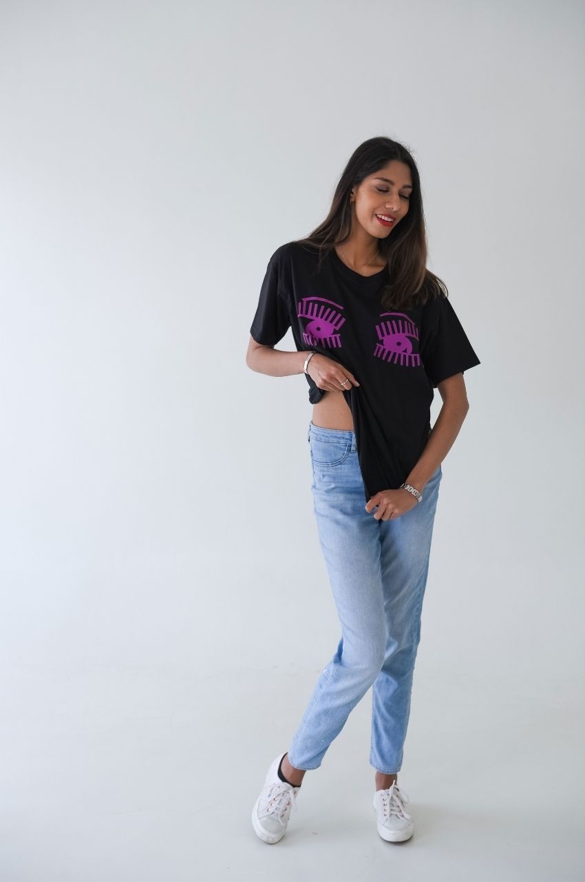 Playful styling of black t-shirt with pink eye graphic modern edgy fashion