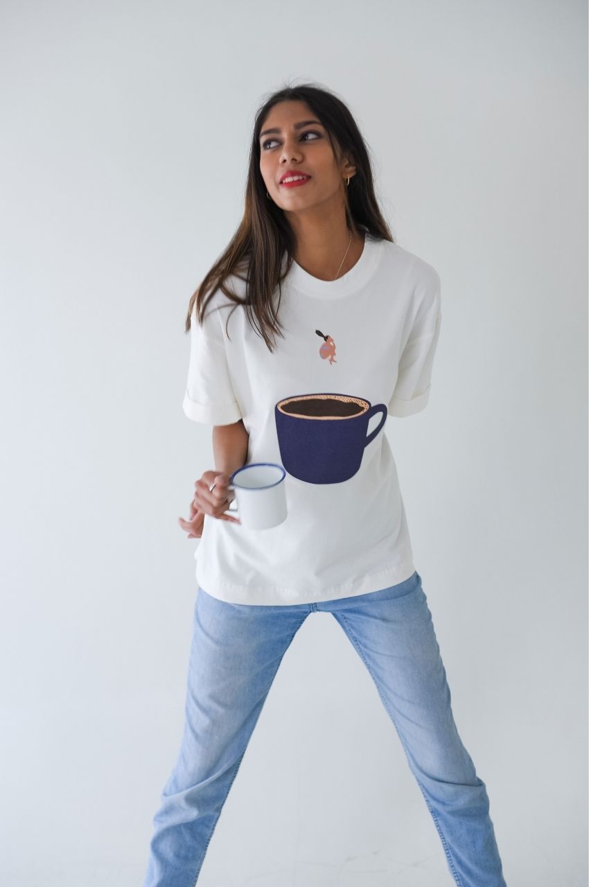 White t-shirt with coffee cup and diving woman illustration styled with jeans casual outfit South Africa