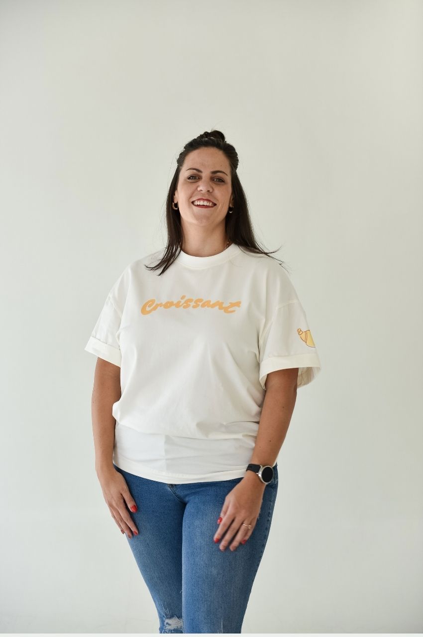 Woman wearing white t-shirt with croissant graphic casual fun fashion South Africa
