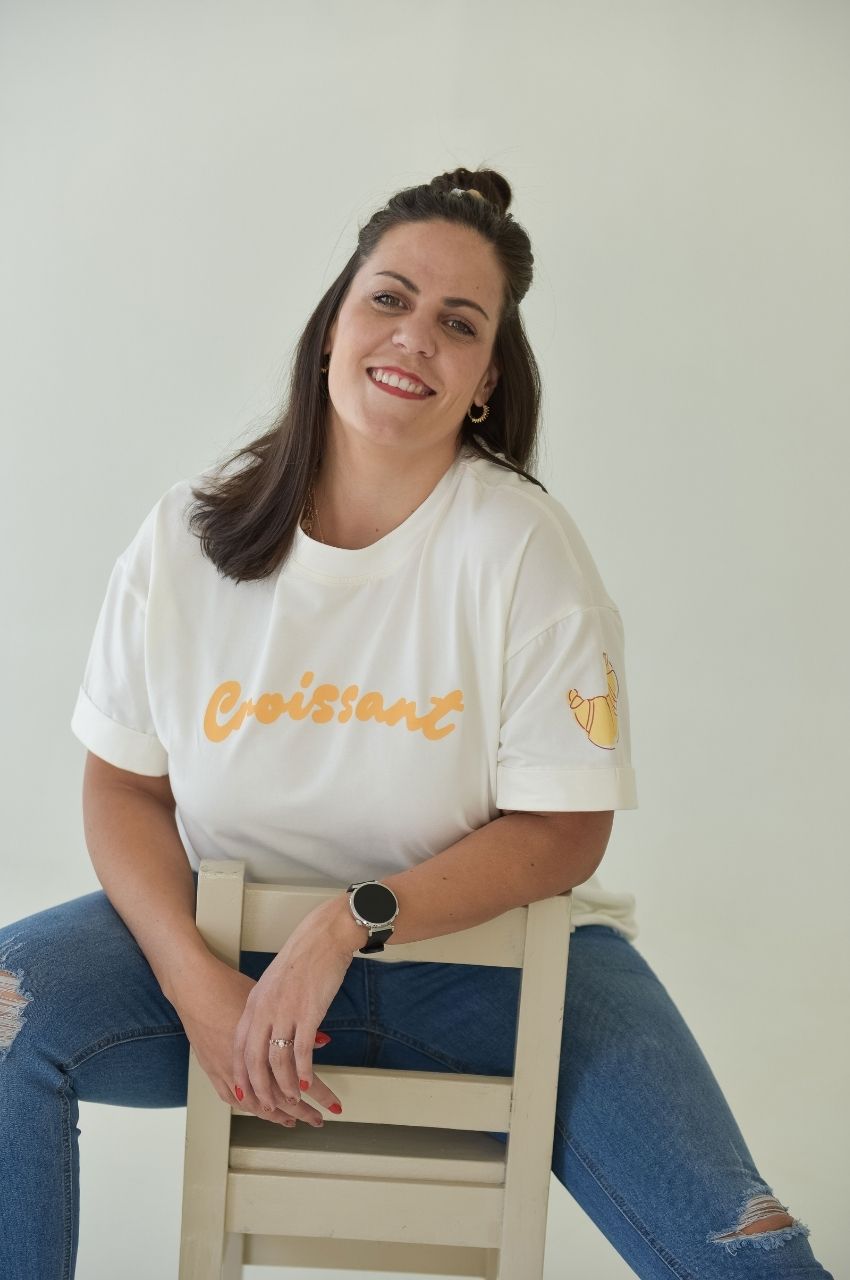 White t-shirt with croissant text design styled casually with denim jeans South Africa
