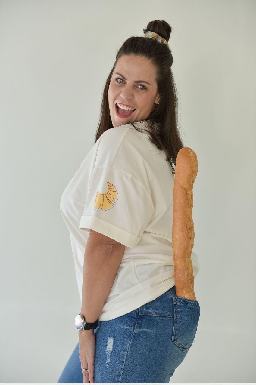Playful woman styling croissant t-shirt with casual jeans quirky fashion South Africa