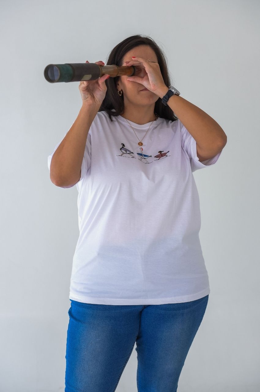 Woman styling playful fish graphic t-shirt with casual denim quirky lifestyle fashion