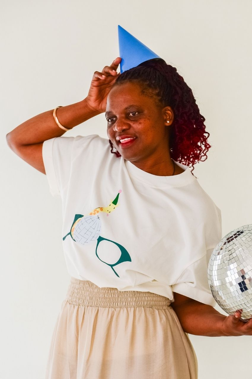 Close up woman wearing white t-shirt with giraffe disco ball illustration fun fashion South Africa