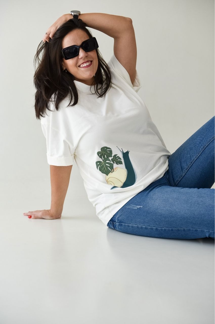 Woman wearing white t-shirt with snail and plant design minimalist nature shirt South Africa