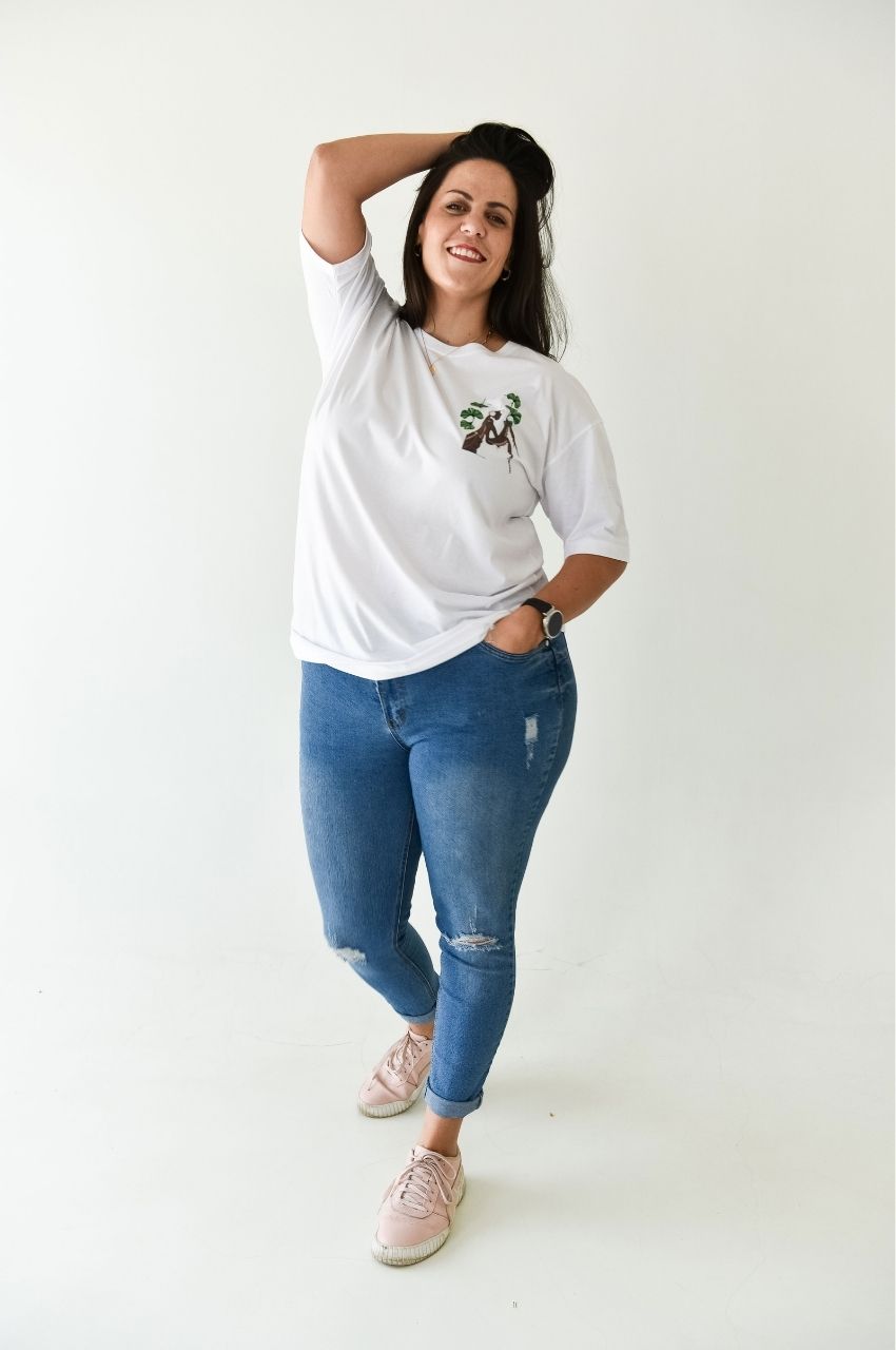 Woman wearing white t-shirt with small nature illustration minimal plant design South Africa