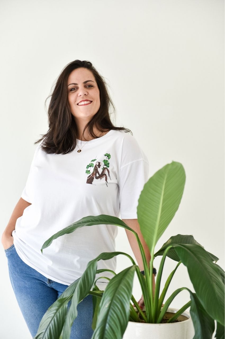 Woman styling minimal nature graphic t-shirt with indoor plant aesthetic South Africa