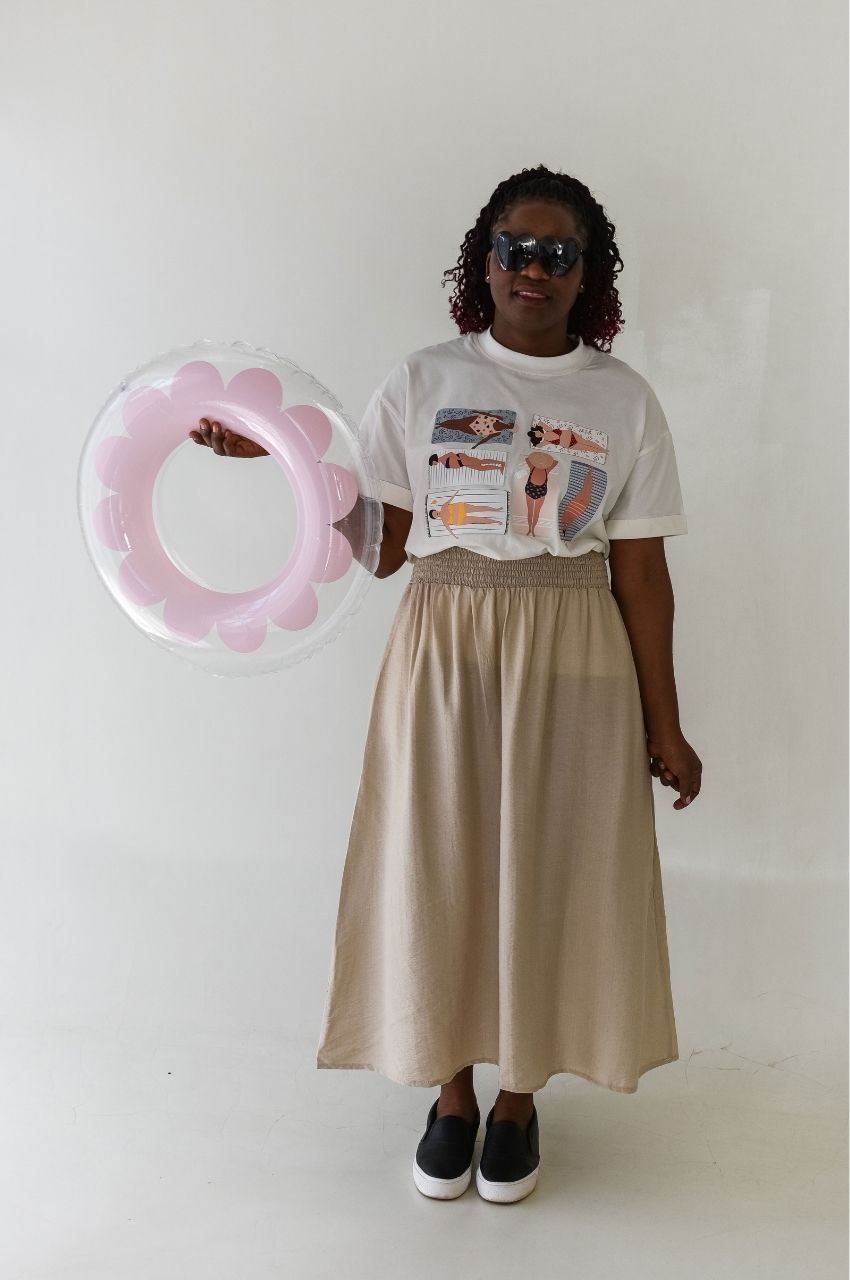 Woman styling body positive beach illustration t-shirt with summer outfit and float South Africa