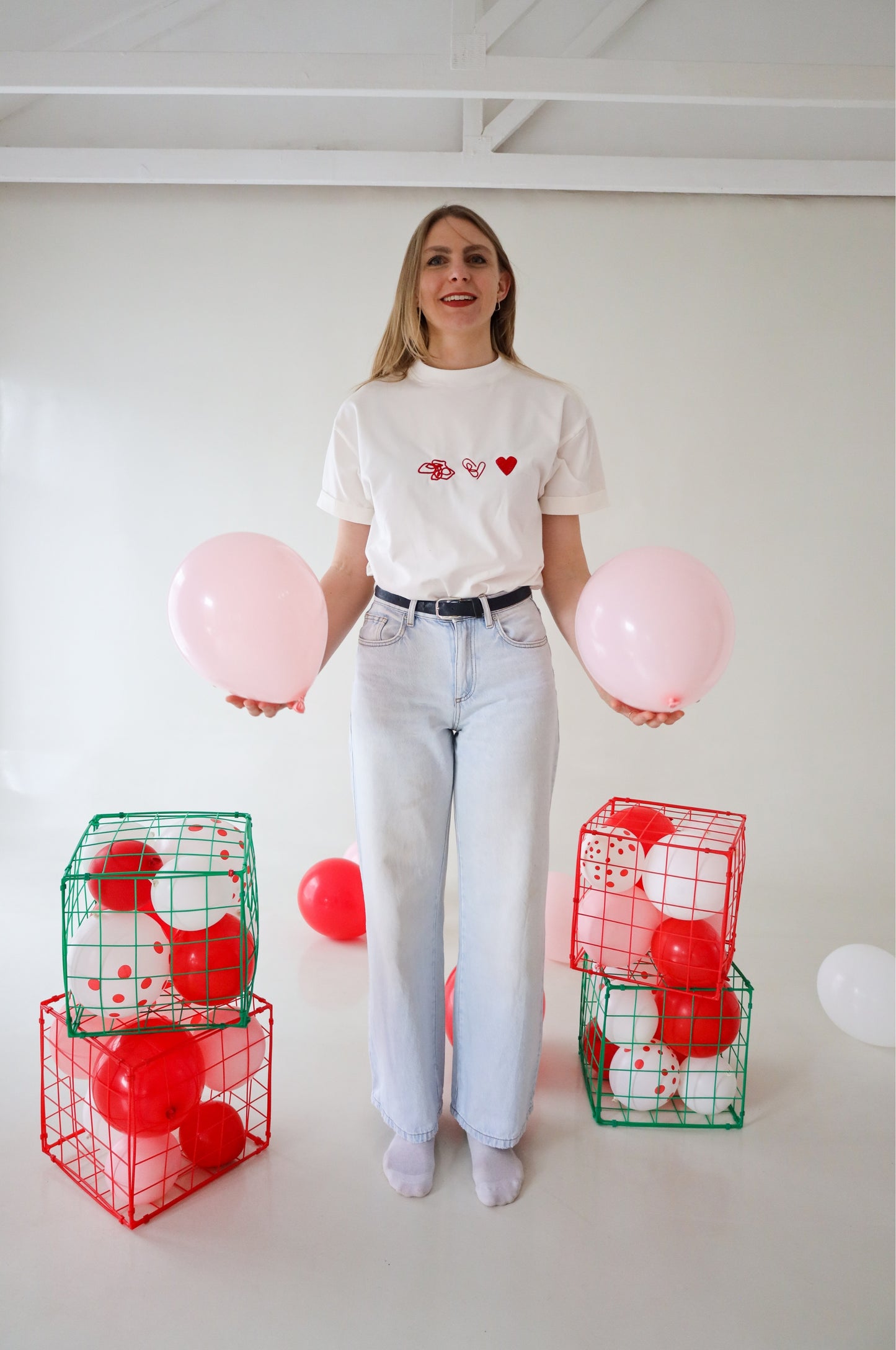 Woman wearing white graphic t-shirt with red heart embroidery, 100% cotton quirky tee with balloons South Africa