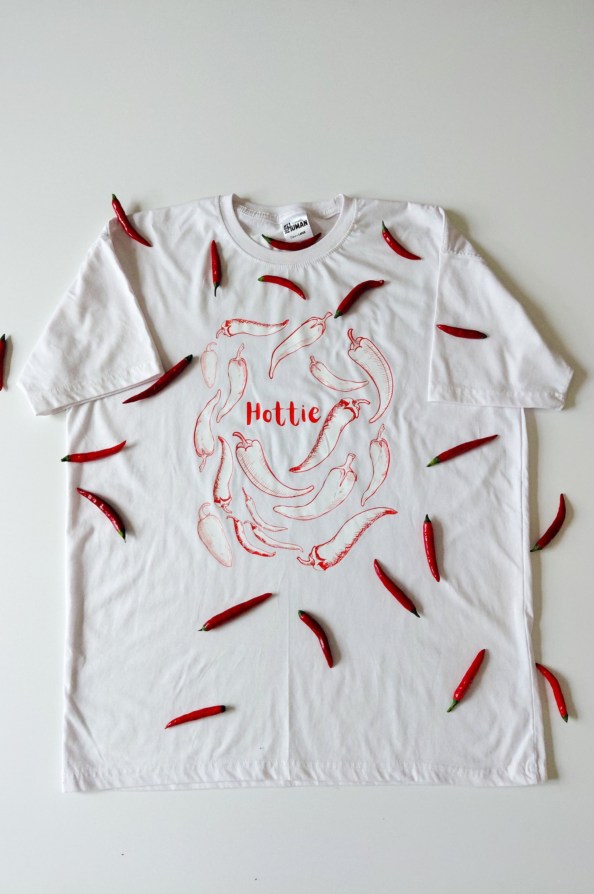White graphic t-shirt with chilli design and Hottie text, quirky 100% cotton funny tee product display South Africa