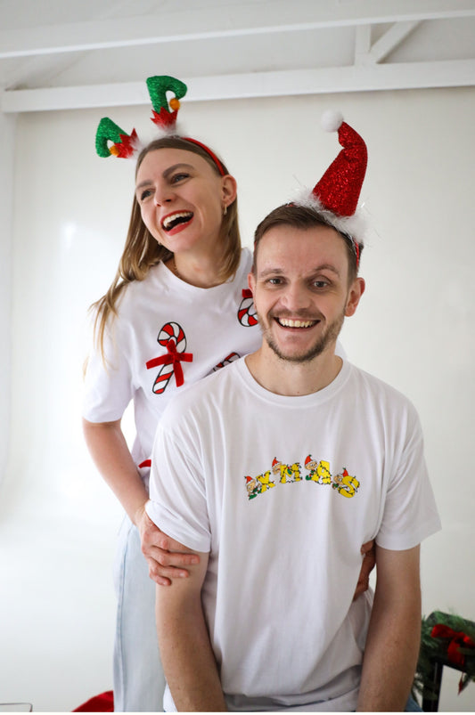 Happy couple wearing funny Christmas t-shirts with XMAS elf design and festive hats South Africa